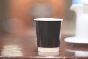 A hand holding a coffee cup  Description automatically generated with medium confidence